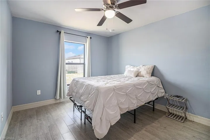 Bedroom 3 featuring tile wood style finished floors and ceiling fan