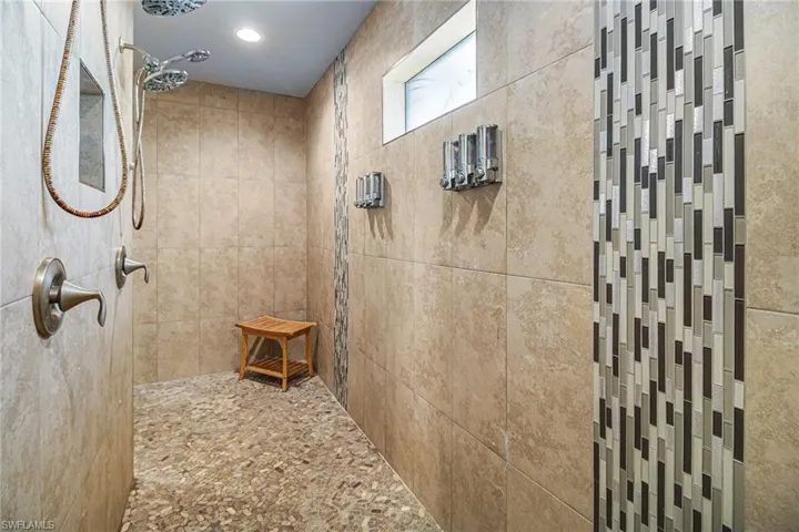 Bathroom with a tile shower and recessed lighting