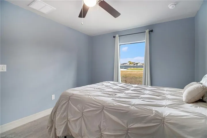 Bedroom 3 featuring a ceiling fan and wood finished floors
