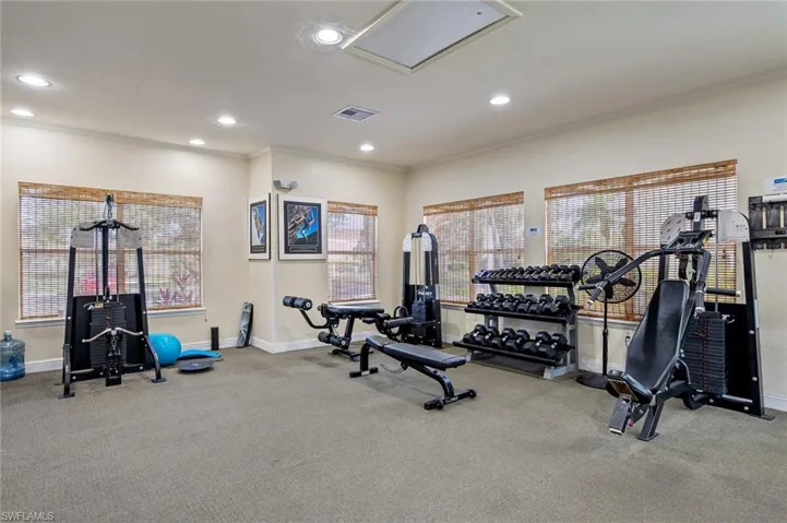 Exercise room featuring weights and machines