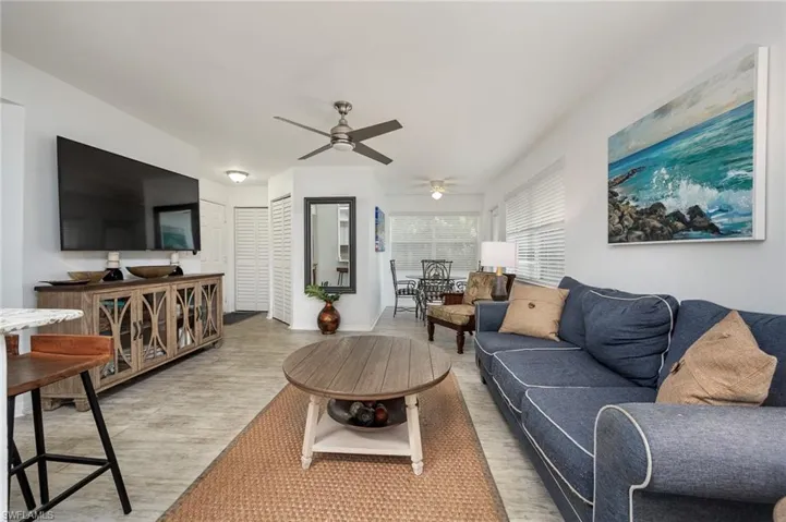 Living room featuring ceiling fan and light flooring
