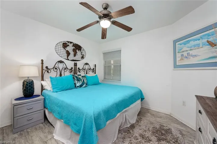 Bedroom featuring light flooring and a ceiling fan