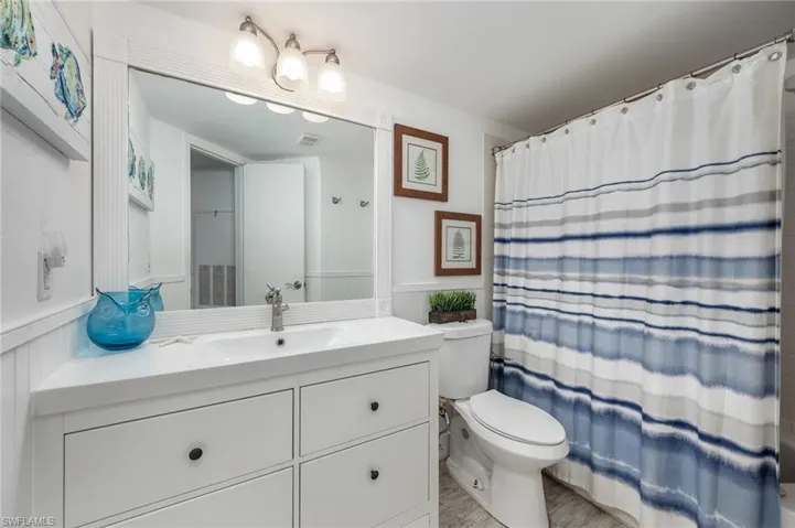 Full bathroom with vanity and shower / bath combo with shower curtain