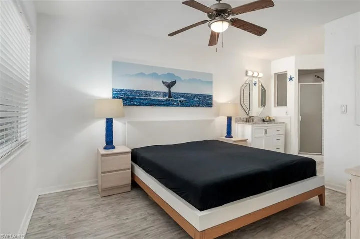 Bedroom featuring a ceiling fan, light flooring, and a window
