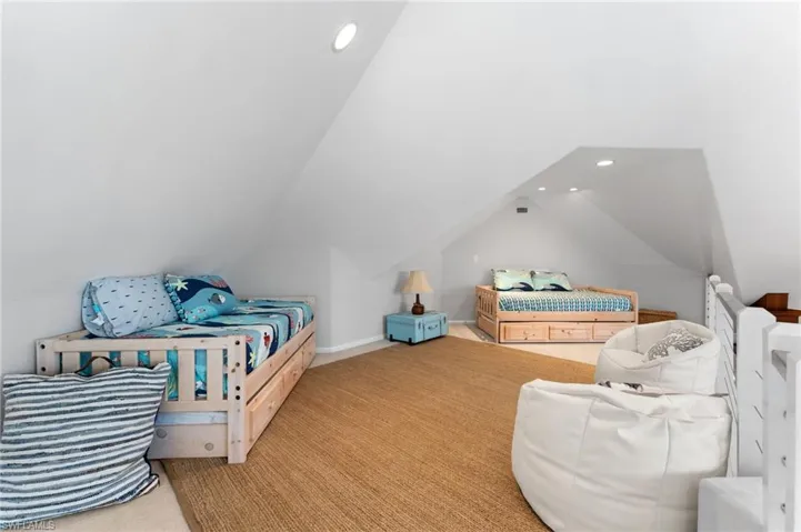Carpeted Loft area with recessed lighting and vaulted ceiling