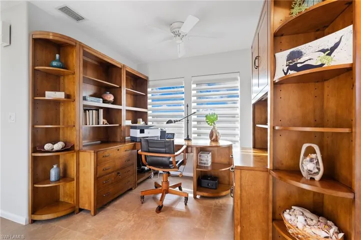 Office space featuring light tile patterned floors and ceiling fan