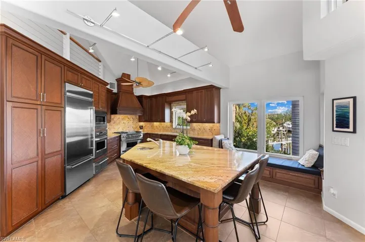 Dining room with ceiling fan and light tile patterned floors