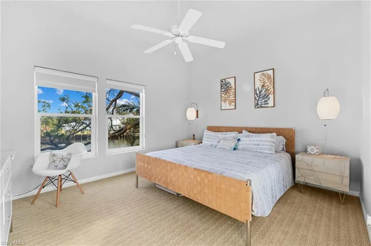 Carpeted bedroom with baseboards and ceiling fan
