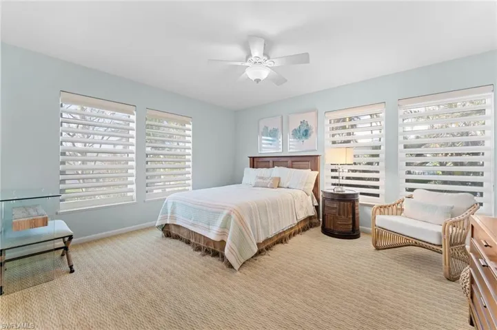 Bedroom featuring light carpet and a ceiling fan