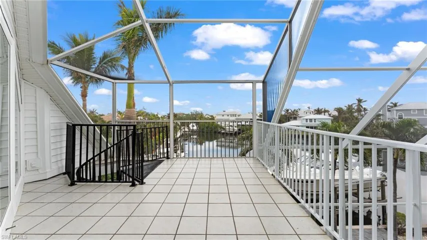 Balcony with a sunroom and a water view