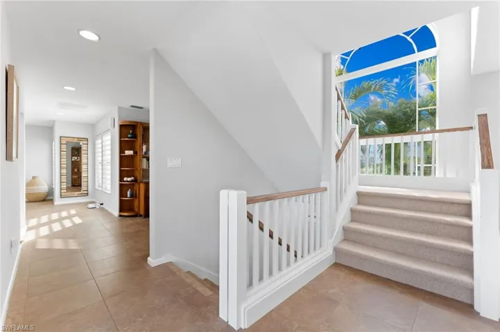 Staircase featuring tile patterned floors and recessed lighting