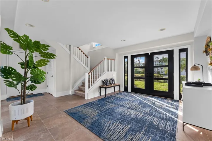 Entrance foyer with french doors, stairway, recessed lighting, and tile patterned floors