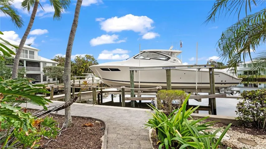Dock area featuring boat lift and a water view