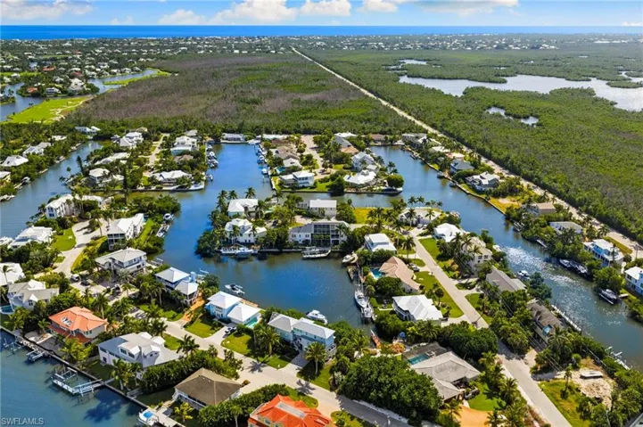 Aerial view of property's location with a large body of water and nearby suburban area