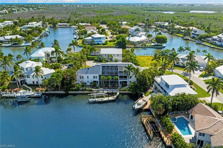 Aerial view of residential area featuring a nearby body of water