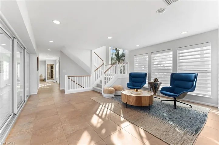 Sitting room featuring recessed lighting, stairs, and light tile patterned floors