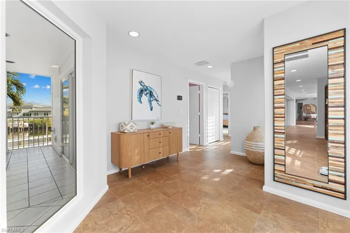 Hallway with baseboards and recessed lighting