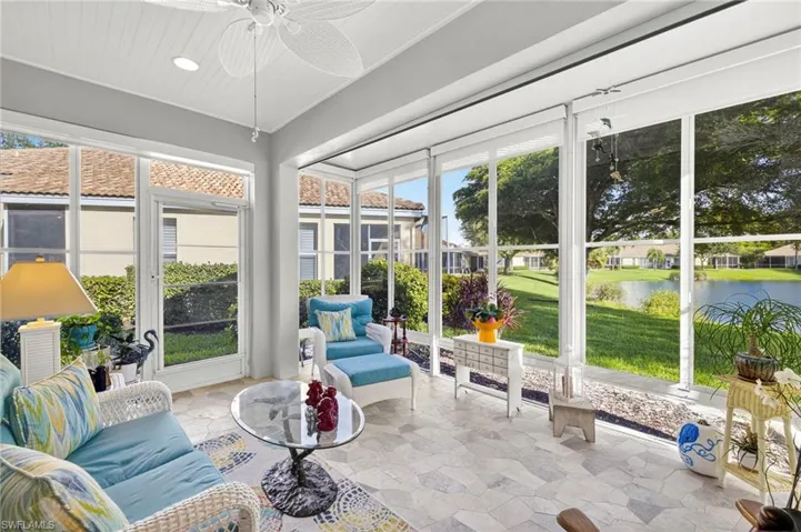 Extended Lanai with a water view, healthy amount of natural light, stone finish floors, and recessed lighting