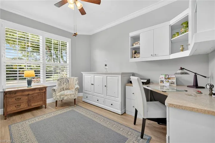 Guest Bedroom/Office space with crown molding, light wood-type flooring, and ceiling fan