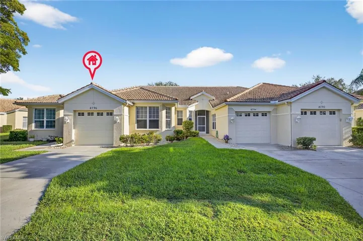 View of front facade with concrete driveway, stucco siding, an attached garage, a front yard, and a tiled roof