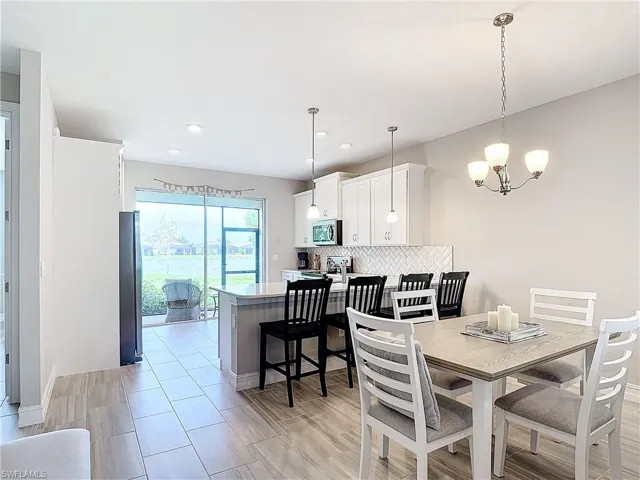 Dining room with a chandelier and recessed lighting