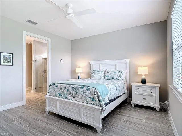 Bedroom with baseboards, wood finish floors, and ceiling fan
