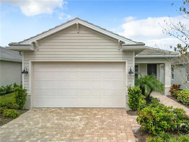View of front of house featuring a garage and decorative driveway