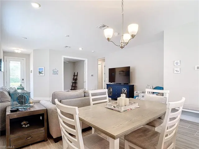Dining area with a chandelier, baseboards, and recessed lighting