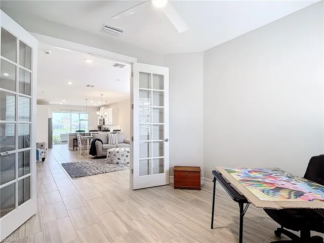 Office area with a ceiling fan, french doors, and recessed lighting