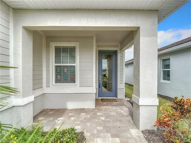 Entrance to property featuring stucco siding