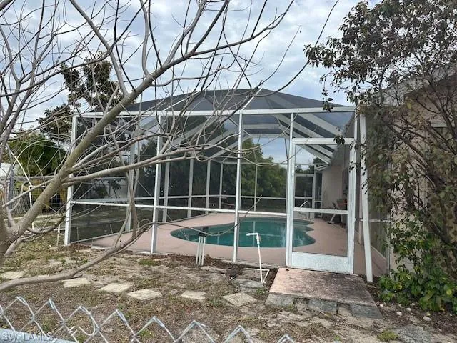Swimming pool with a sunroom, a patio, and a lanai
