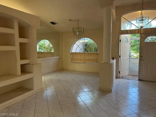Foyer with a chandelier and light tile patterned floors