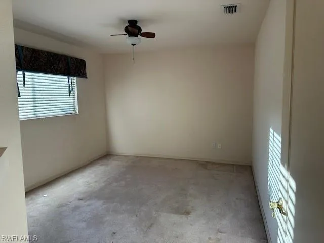 Unfurnished room with carpet flooring and a ceiling fan