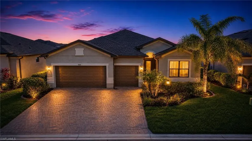 Contemporary stucco exterior with a multi-car paver driveway