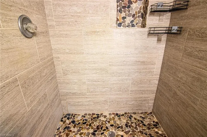 Bathroom featuring tiled shower