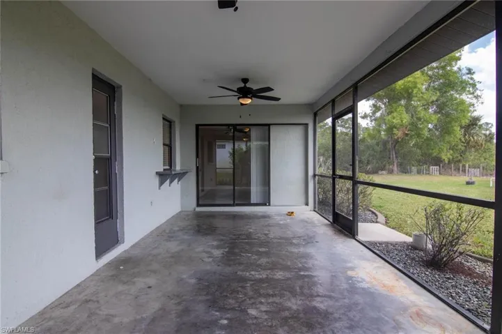 Unfurnished sunroom featuring a ceiling fan