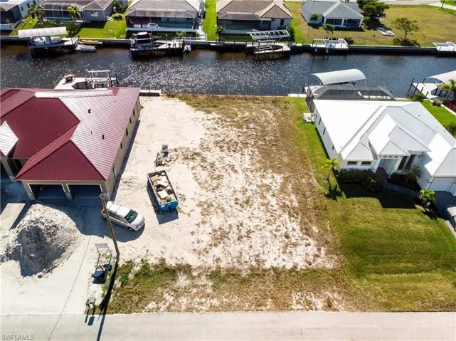 Aerial perspective of suburban area featuring a large body of water