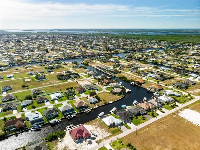 View of property location featuring a nearby body of water and nearby suburban area