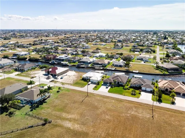 Aerial view of residential area featuring a nearby body of water