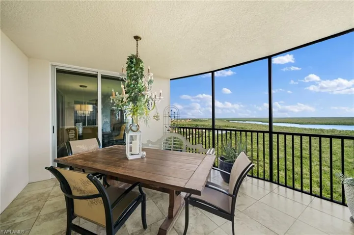 Sunroom / solarium featuring a water view and a wealth of natural light