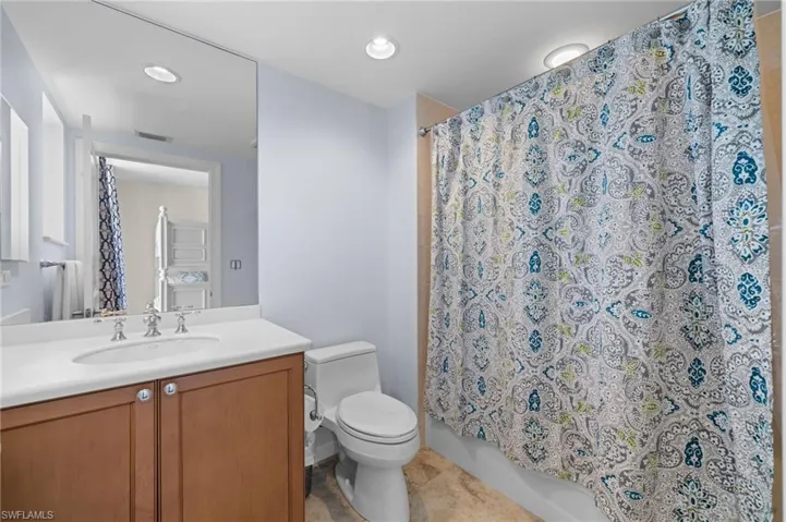 Full bathroom featuring vanity, toilet, and shower / tub combo