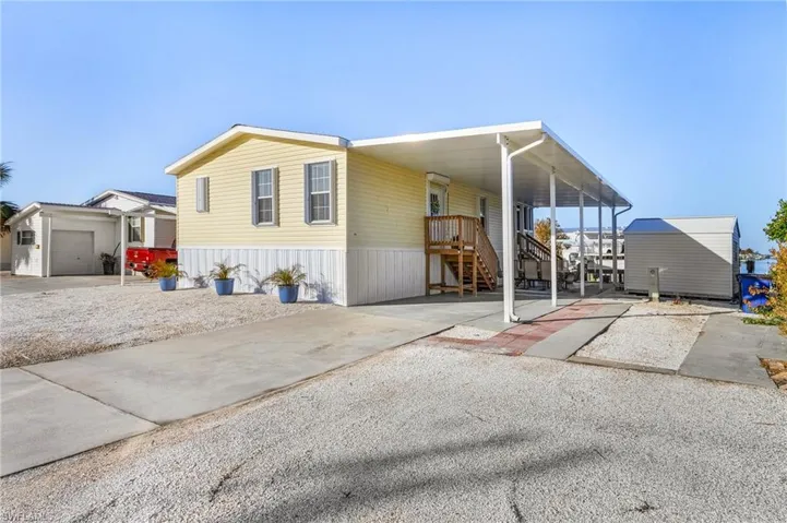 Manufactured / mobile home featuring a garage and a carport