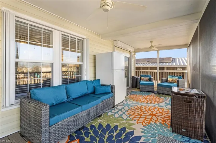 Sunroom featuring beamed ceiling, a healthy amount of sunlight, and ceiling fan