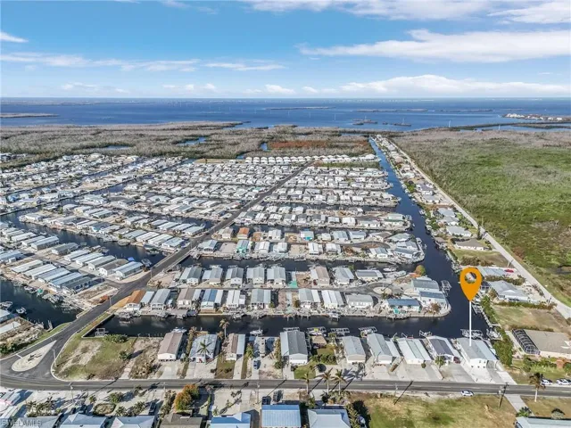 Birds eye view of property with a water view