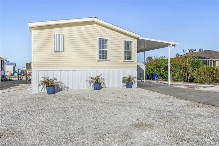 View of side of property featuring a carport
