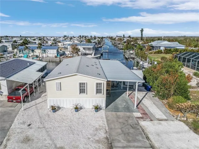 Birds eye view of property with a water view