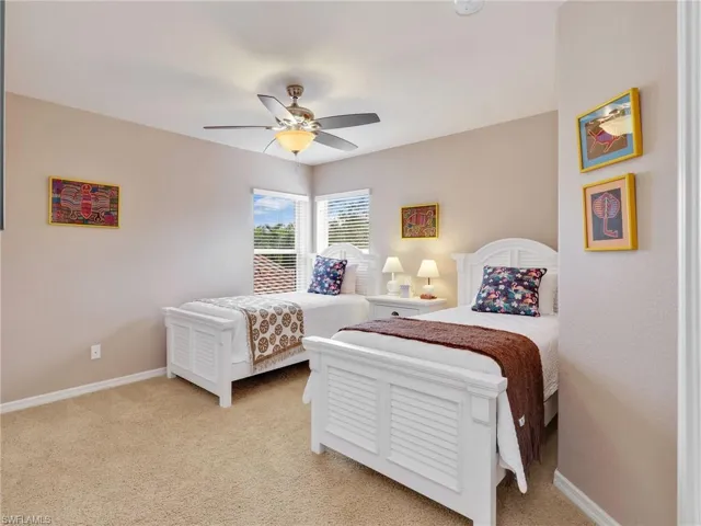 Bedroom with light carpet and ceiling fan
