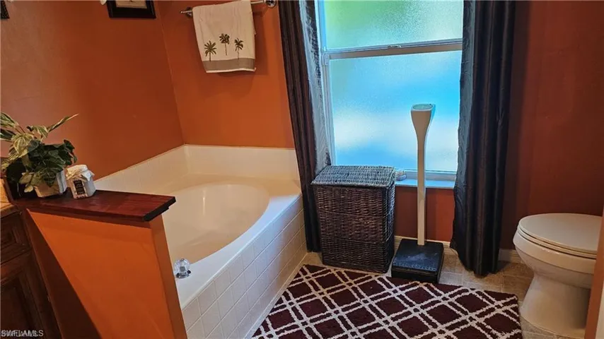 Full bath featuring a bath and toilet