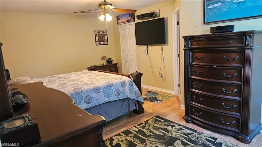 Bedroom with wood finished floors and a ceiling fan