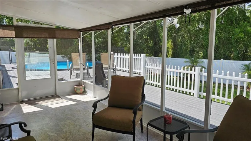 Sunroom / solarium featuring plenty of natural light and lofted ceiling
